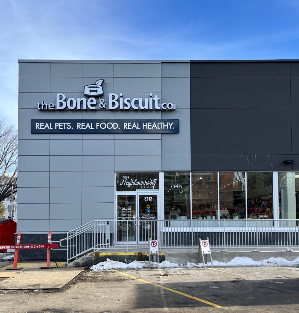 The outside of the Bone & Biscuit Garneau location on a sunny day, a pet supply store in Edmonton, Alberta.
