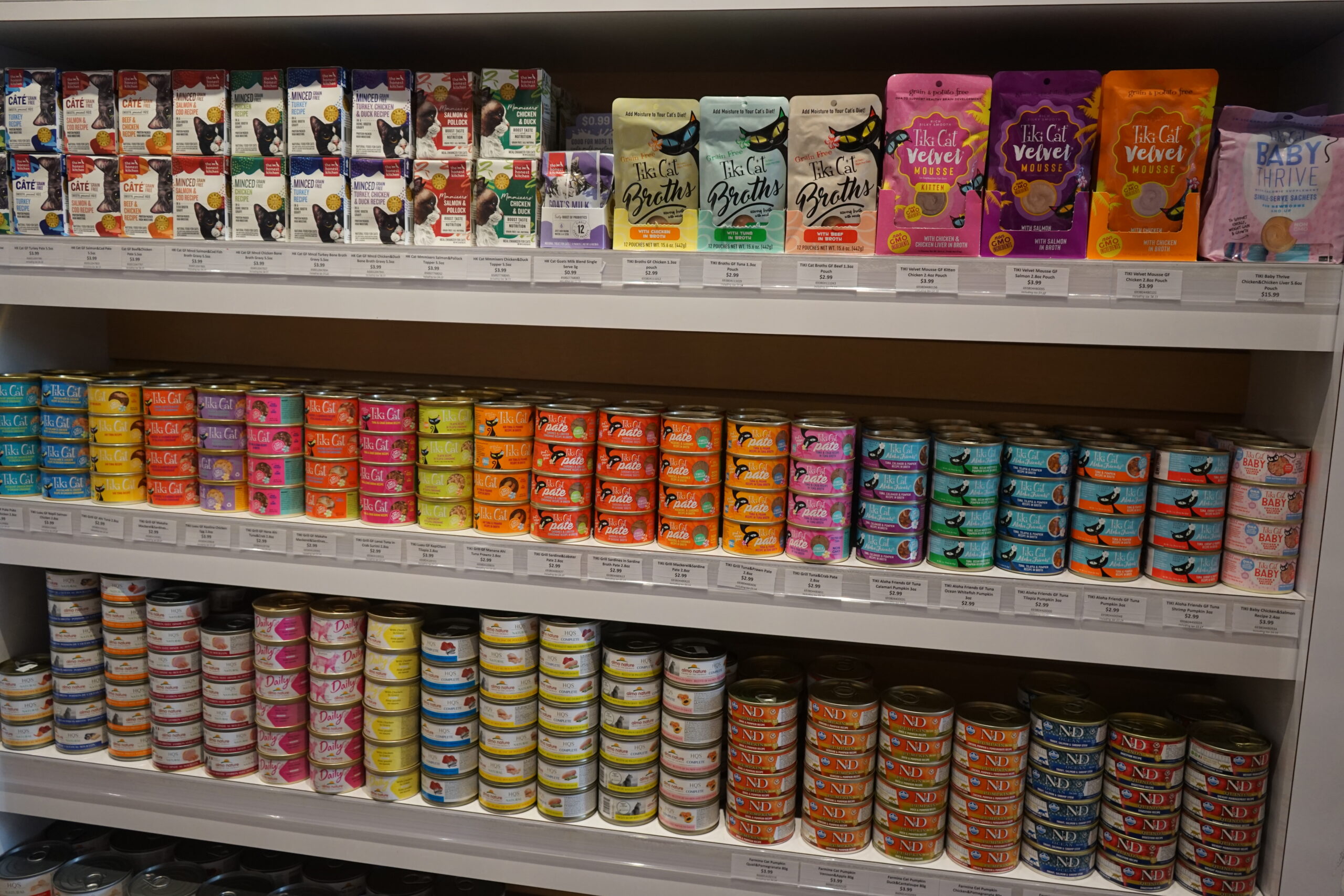 The canned food display shelfs of pet food at Bone & Biscuit Okotoks, a pet supply store in Okotoks Alberta with new owners.