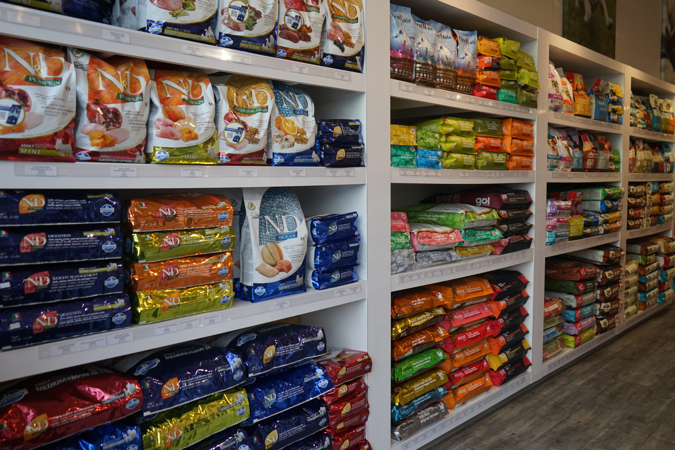 The dry food display shelfs of pet food at Bone & Biscuit Okotoks, a pet supply store in Okotoks Alberta with new owners.