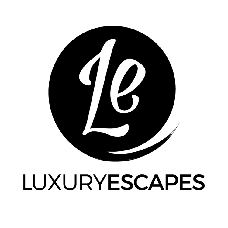 Black circle logo with white cursive "Le," bold "LUXURYESCAPES" below; highlights Caerula Mar Club, South Andros Bahamas.