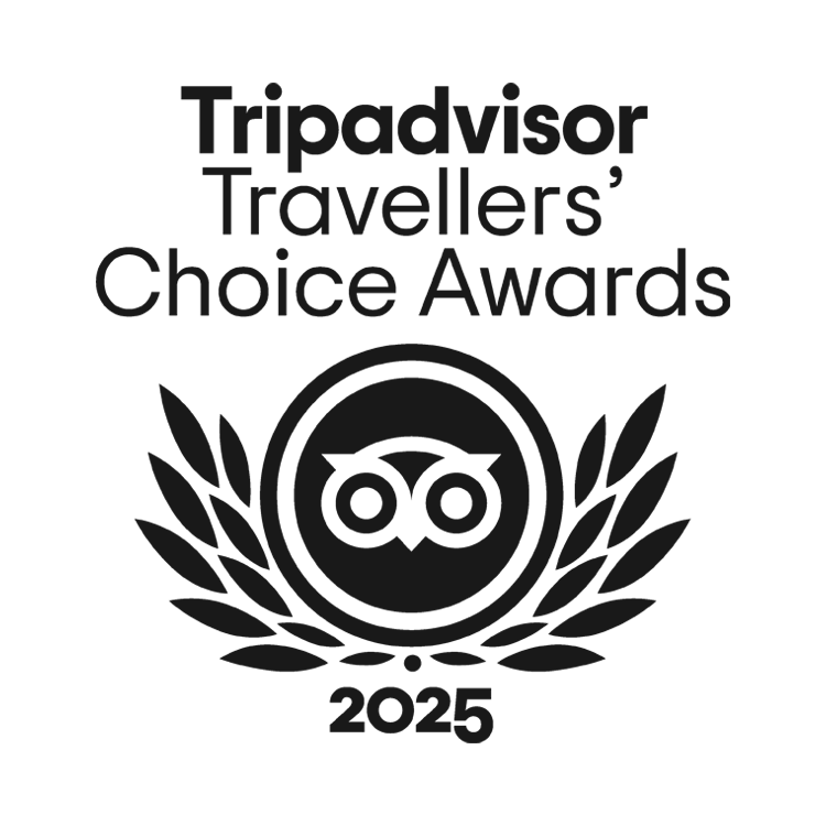 Elegant black and white TripAdvisor 2025 Travellers’ Choice Awards logo honoring Caerula Mar Club, luxury resort in The Bahamas.